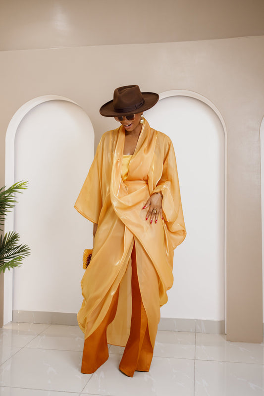 Nahota Kanma Fadilla Set in gold and orange, showcasing a structured patterned blazer and flowing wide-leg pants for sophisticated formal wear.