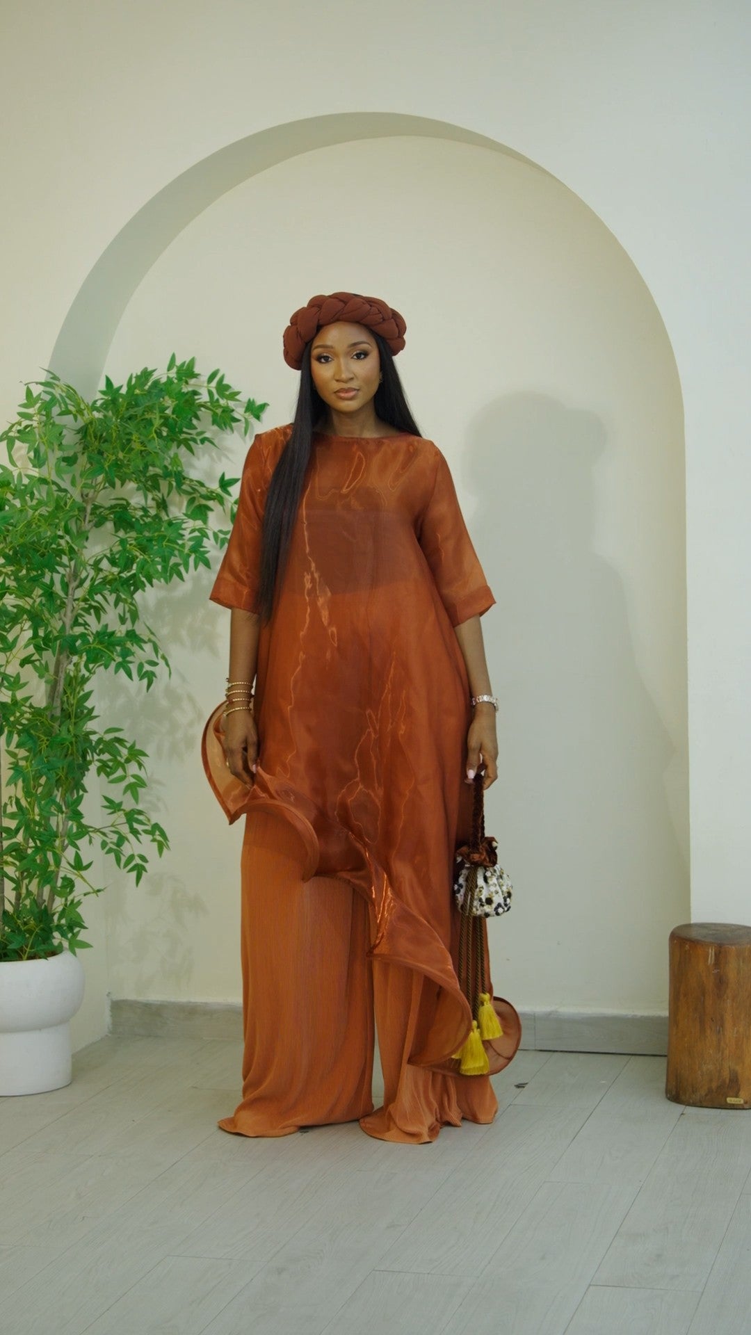 Earth tone Emuna Set (sheer organza tunic with plisse pants) from Nahota Kanma, featuring asymmetrical hem and ruffle details.