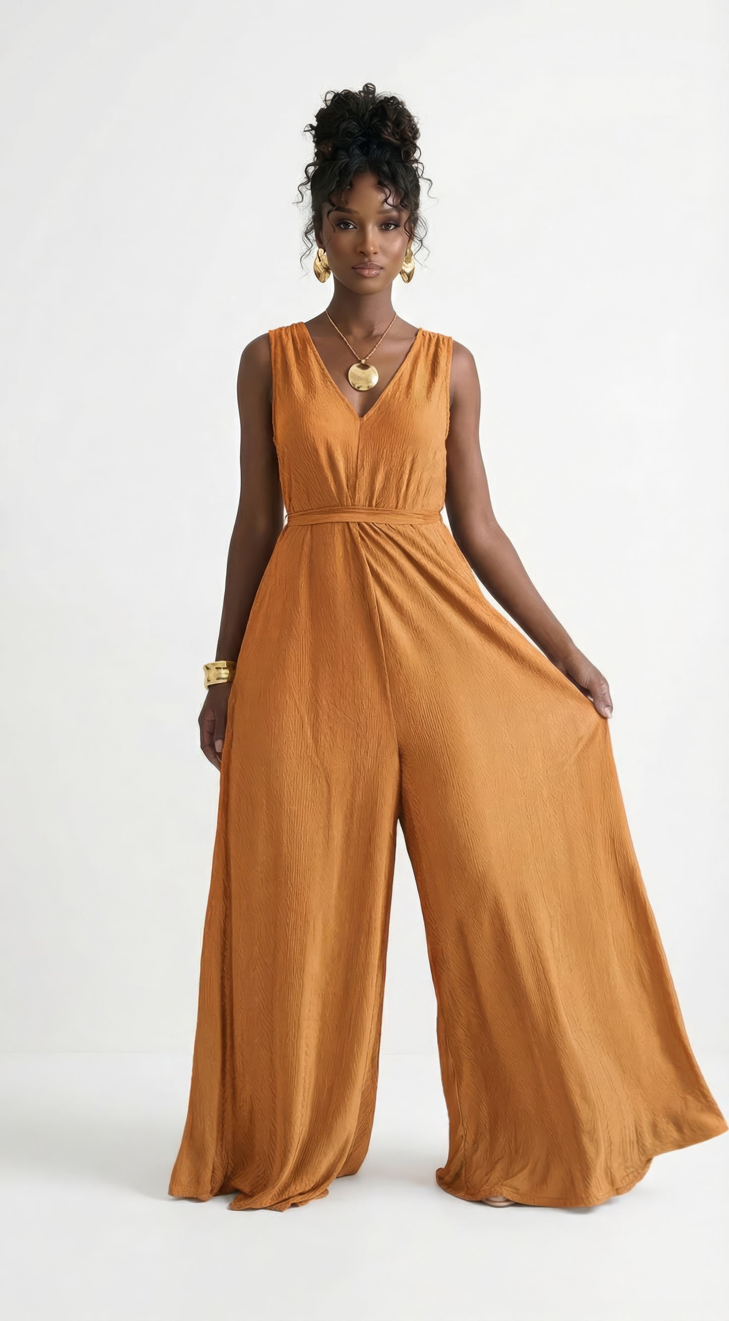 Saeeda Jumpsuit in vibrant burnt orange worn by a model.