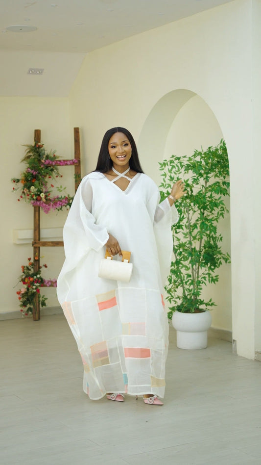 Off-white Vered Kaftan from Nahota Kanma's Bojagi Collection, showcasing seersucker fabric and patchwork details.