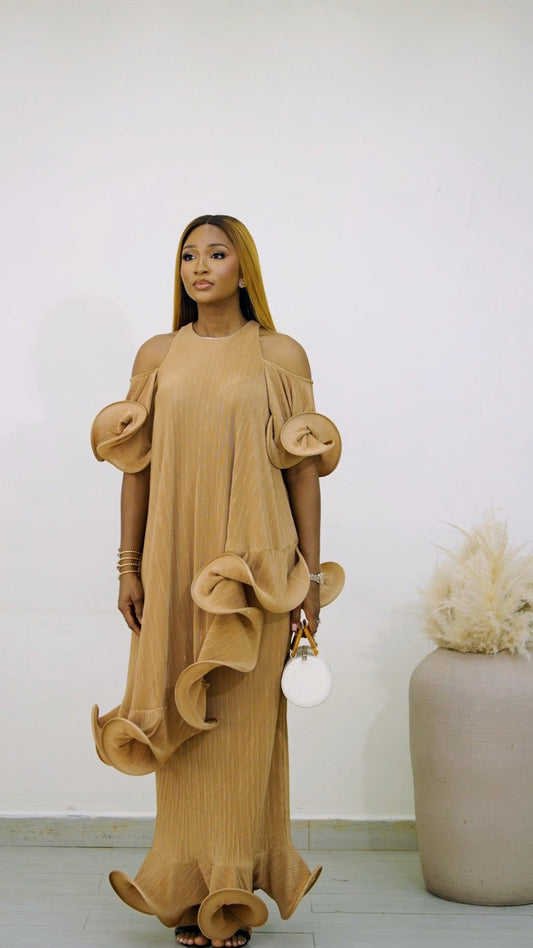 Light brown Hila Set (plisse skirt set) from Nahota Kanma, featuring cold-shoulder, ruffled sleeves, and tiered ruffles on hem.
